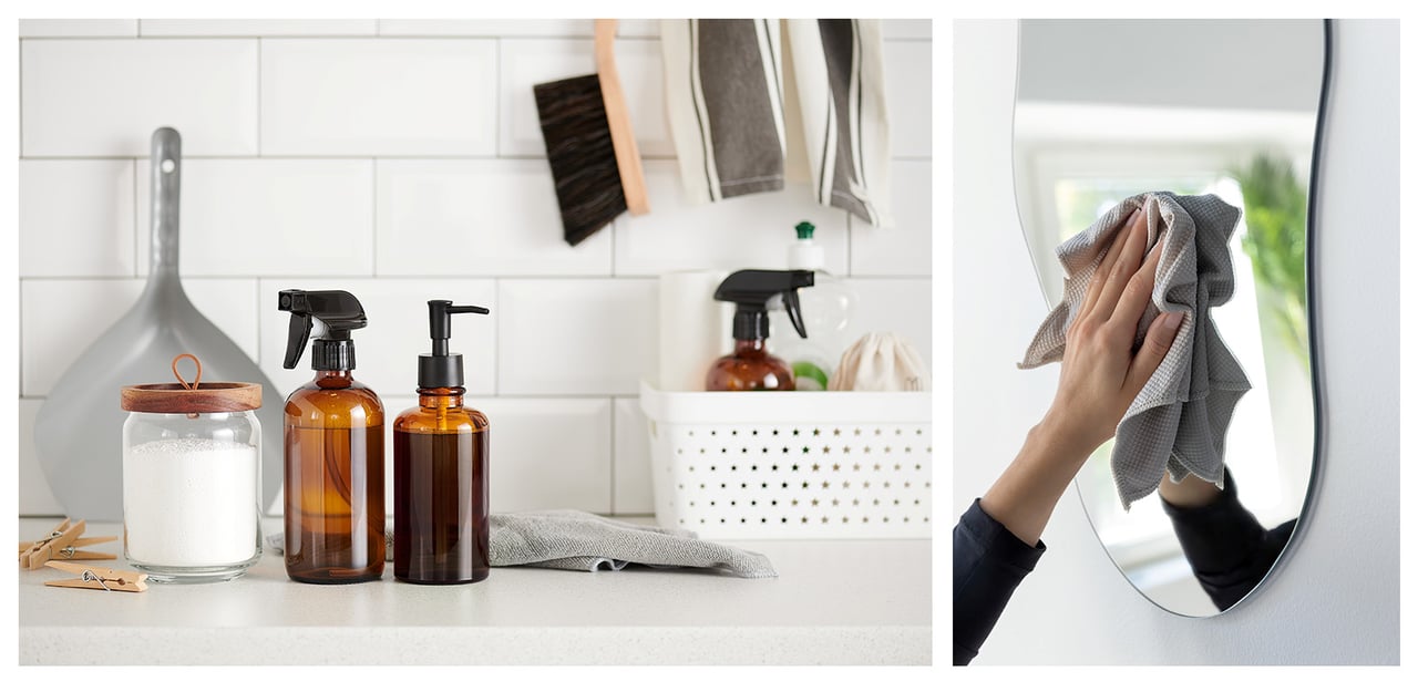 Sprühflasche, Seife und Reinigungsmittel auf einer weißen Badezimmerablage. Hand in Nahaufnahme, die einen Spiegel abwischt.