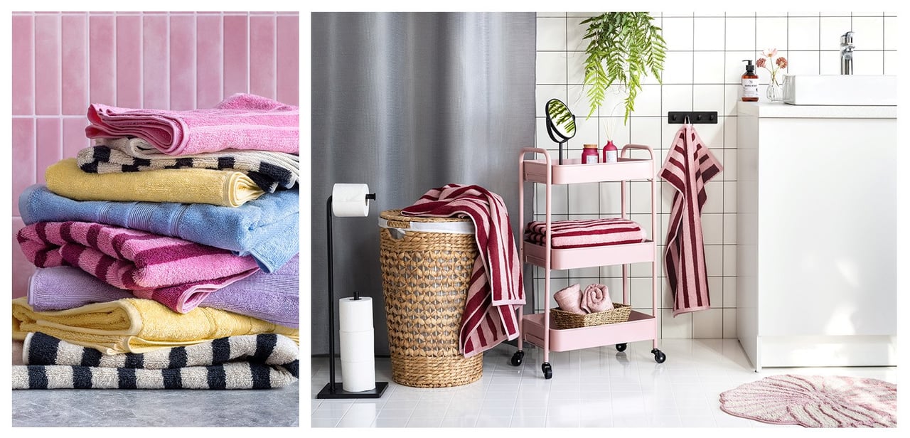 Fargerike håndklær i en stabel og et bad med innredning i rødt og rosa.