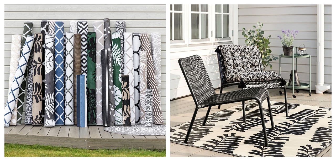 Aufgerollte Outdoor-Teppiche in Blau und Erdfarben aufgestellt an einer weißen Wandfassade.