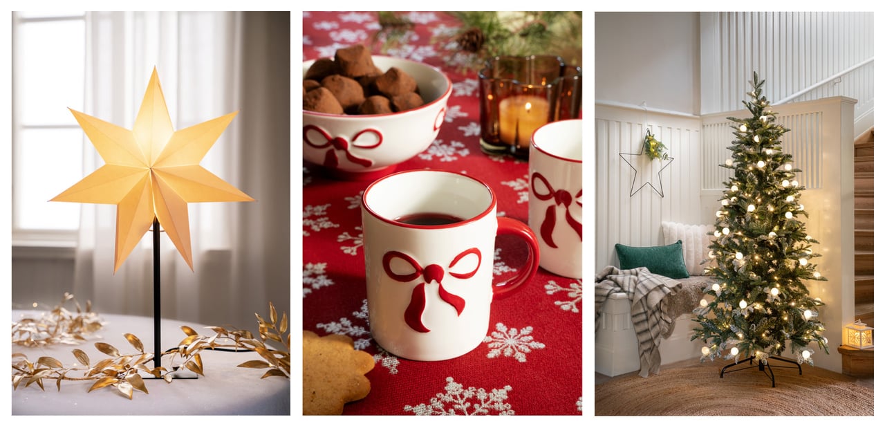 Julstämning med lysande adventsstjärna på fot, muggar med röda rosetter och julgran klädd med ljusslinga.