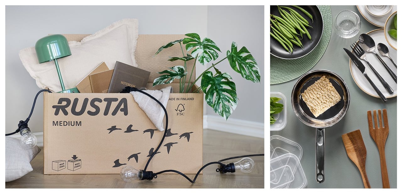 Flyttlåda med lampor, en växt och kuddar. Köksprodukter som skärbräda, kastrull, stekpanna och matlådor.