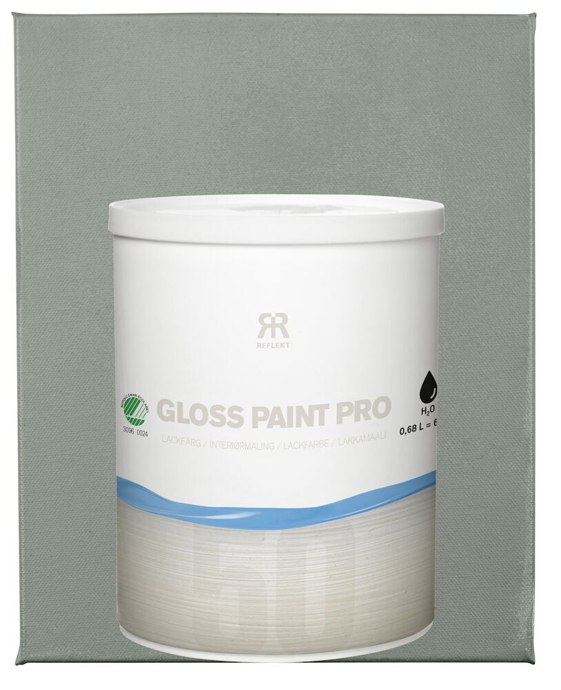 Valkoinen purkki puolikiiltävällä vihreällä lakkamaalilla vihreällä pinnalla.