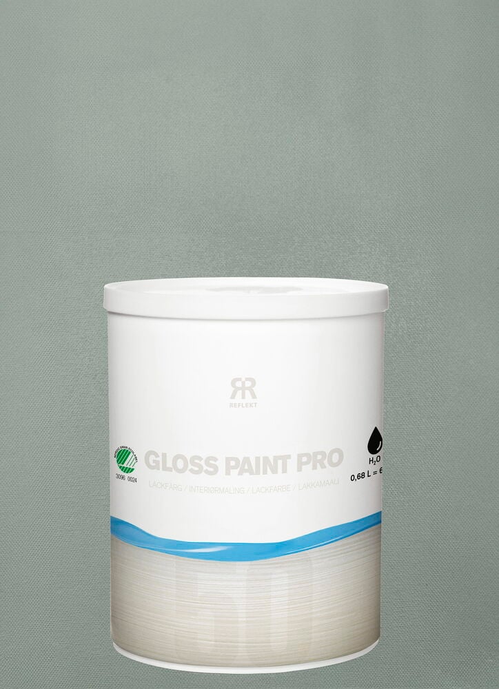 Valkoinen purkki lakkamaalia eukalyptuksenvihreällä taustalla.