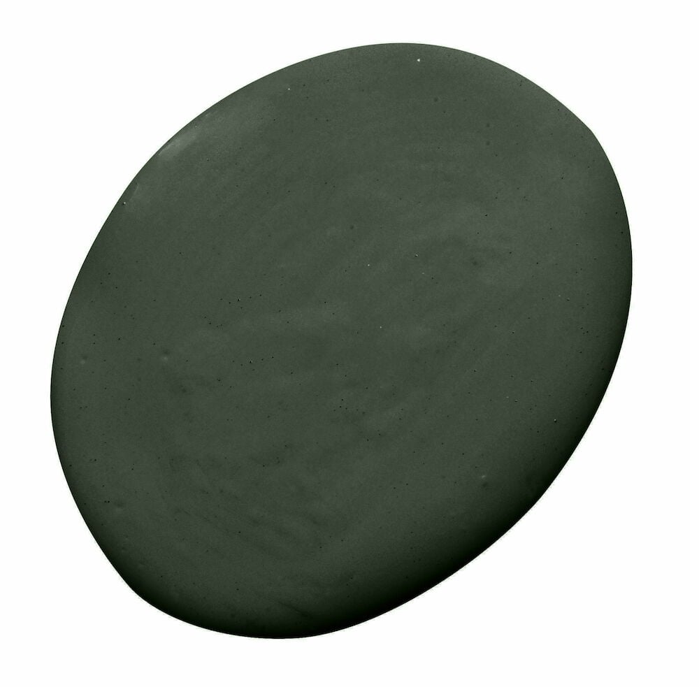 Mörkgrön rund färgklick med matt yta.