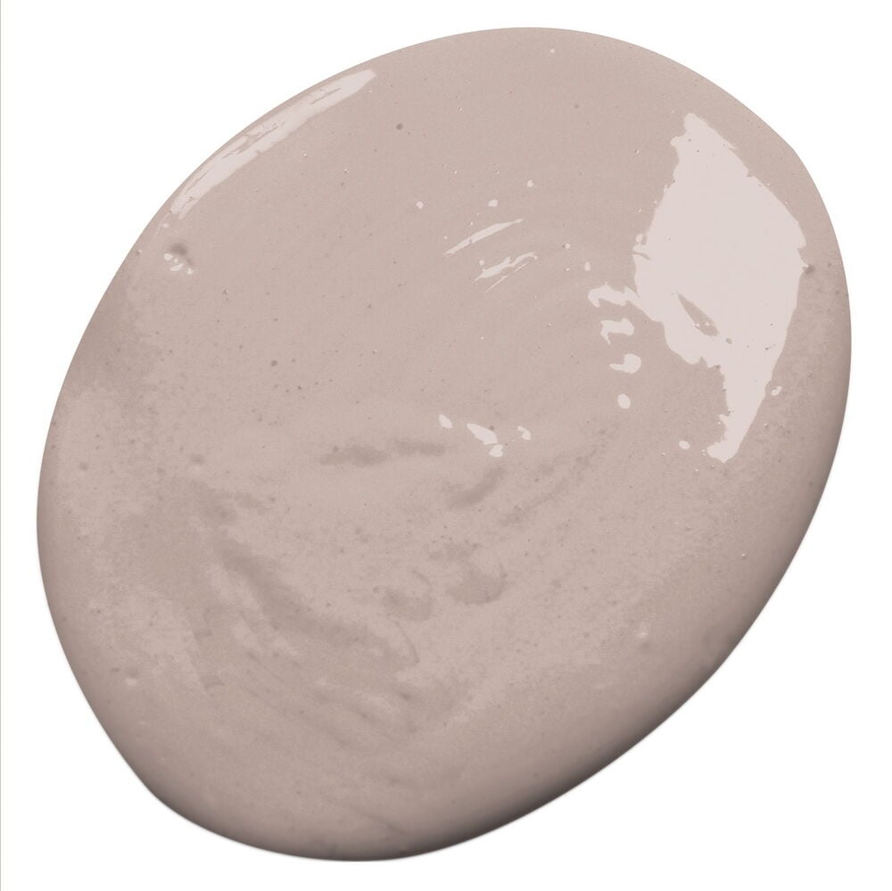 En ovalformad klick mjuk rosa Nyans väggfärg med subtil glans och texturerade virvlar.