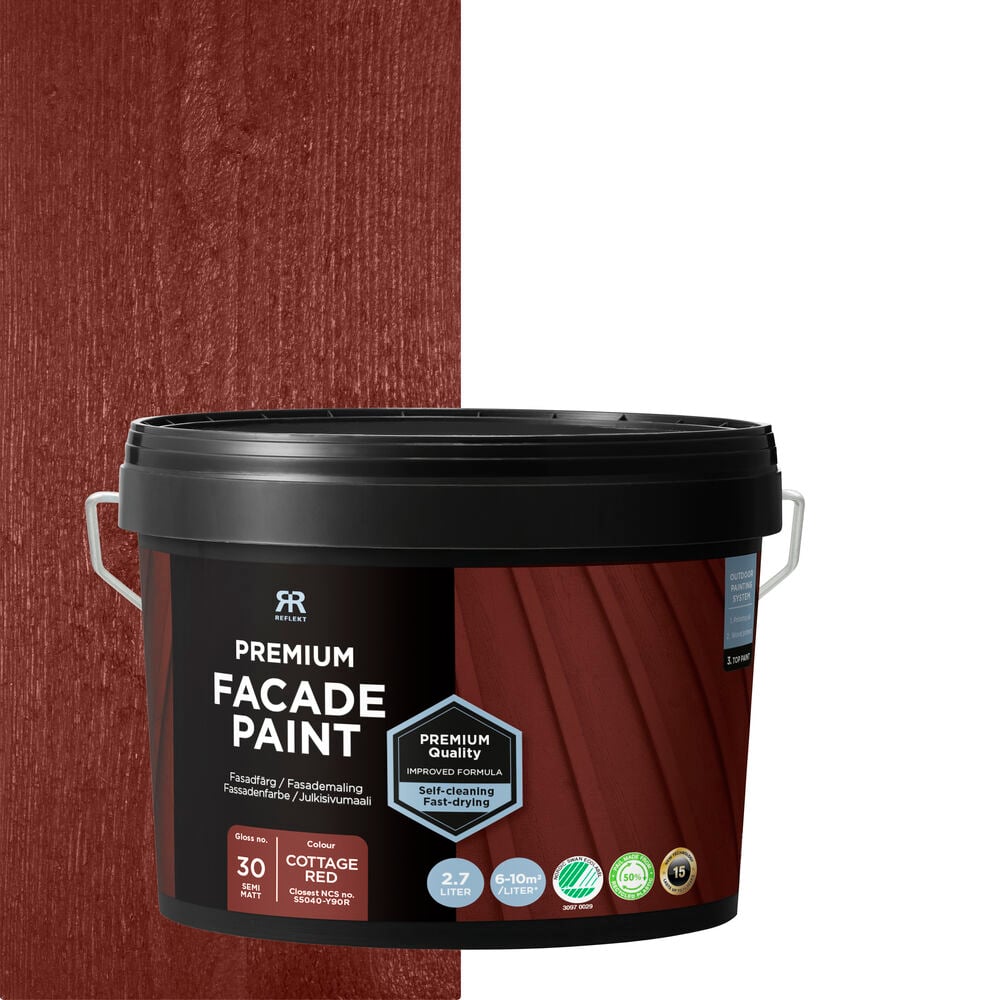 Burk med röd fasadfärg mot träbakgrund.