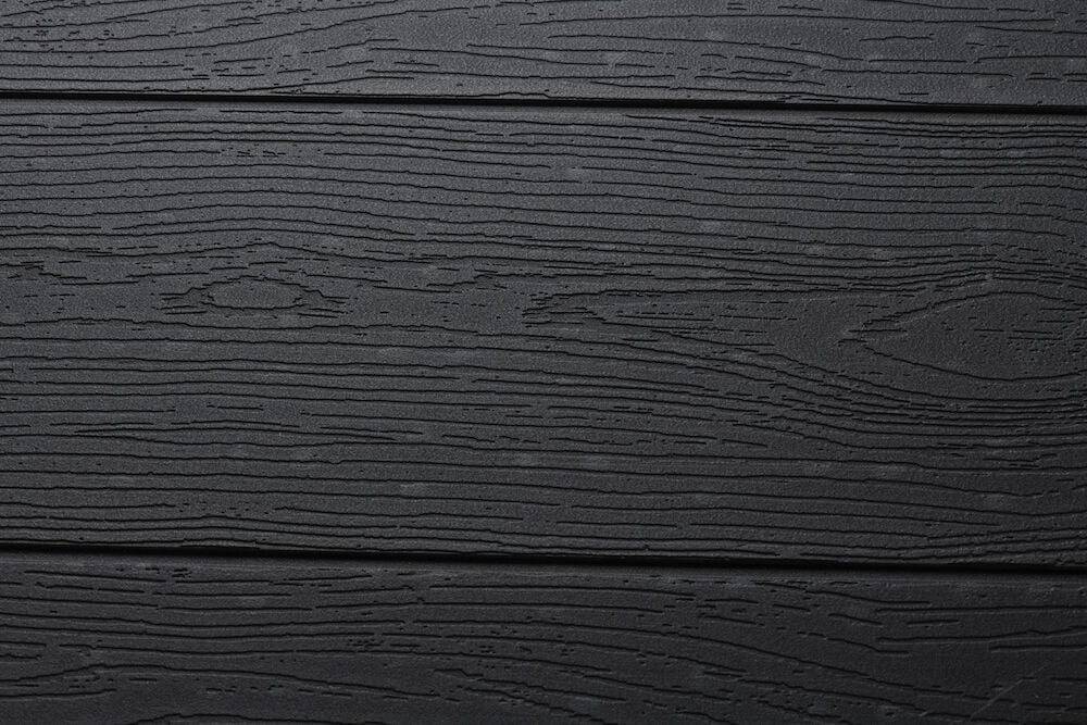 Svart bordsskiva med träliknande struktur och yta.