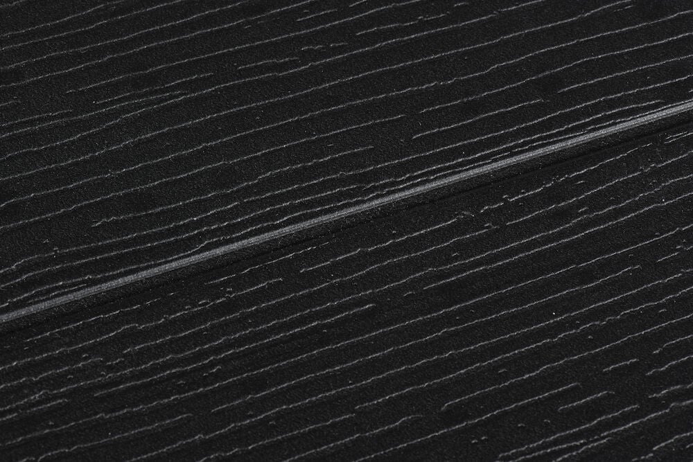 Svart bordsskiva med träliknande mönster och vikbar skarv.