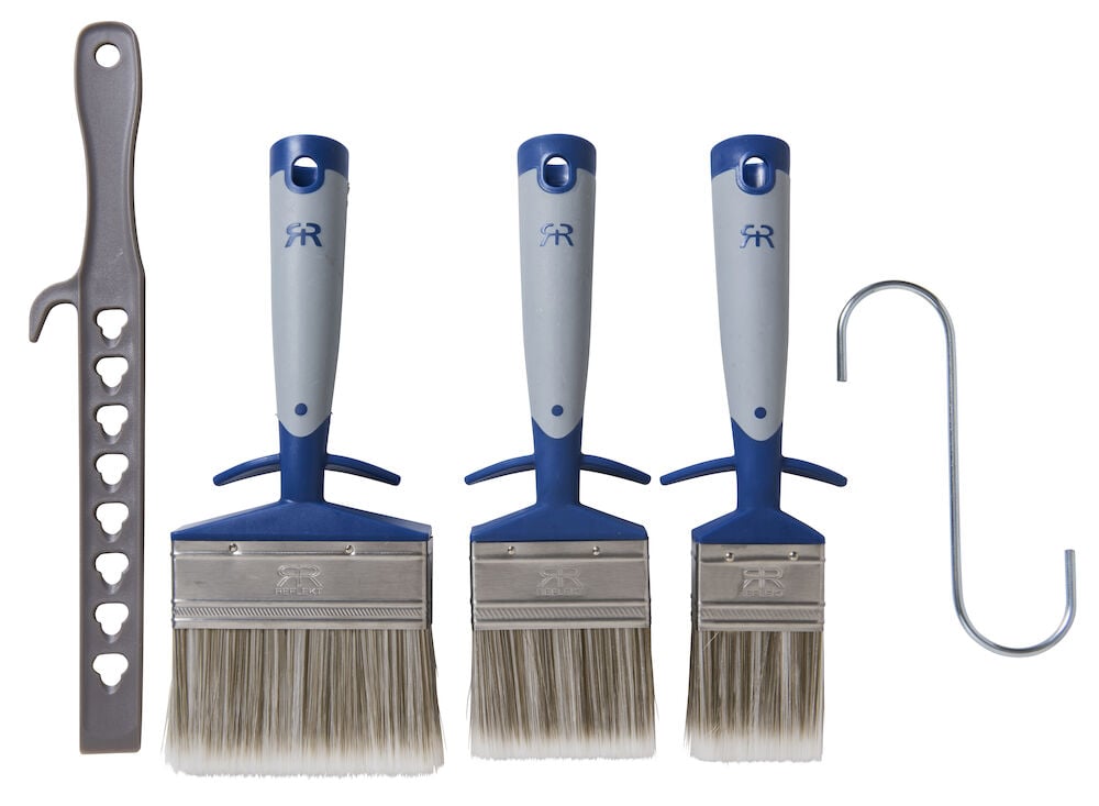 Tre platta penslar med grå och blå handtag.