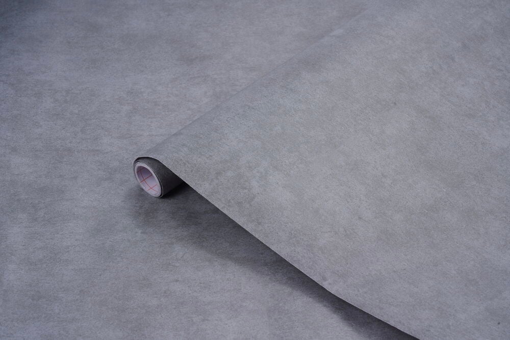 Grå Dekorplast 200x67,5 cm rull, delvis utrullet, som viser den teksturerte overflaten og hvite kjernen.