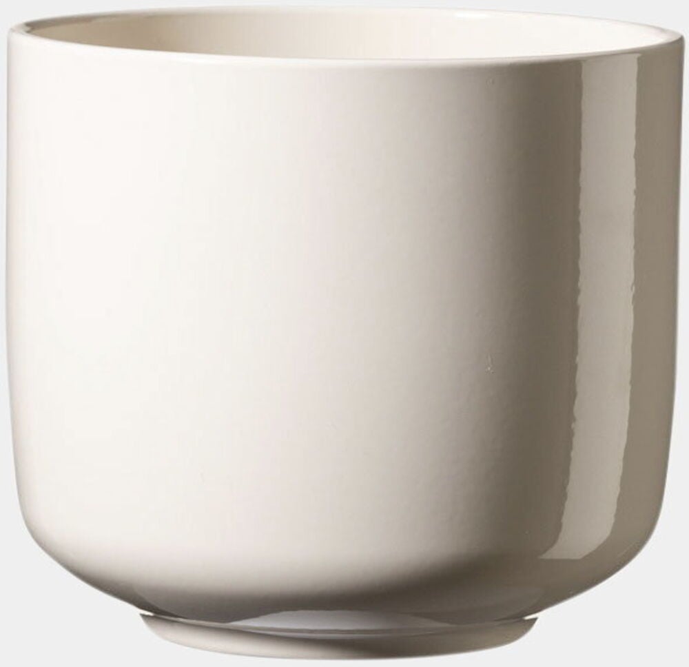 Kermanvärinen pyöreä ruukku, jossa on sileä pinta.