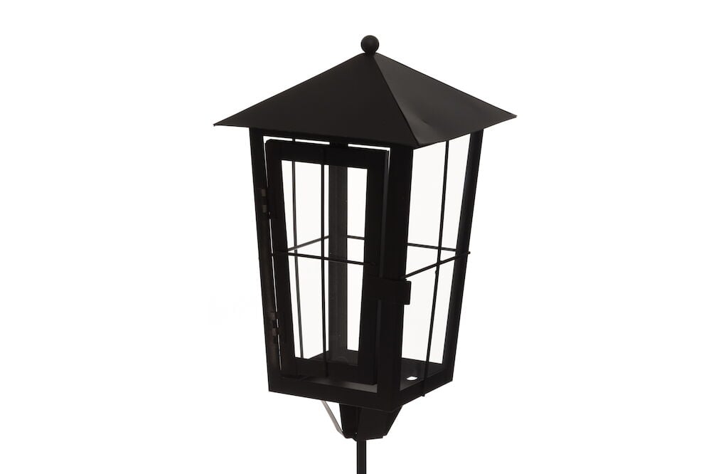 Musta metallinen hautalyhty, jossa pitkä varsi ulkokäyttöön.