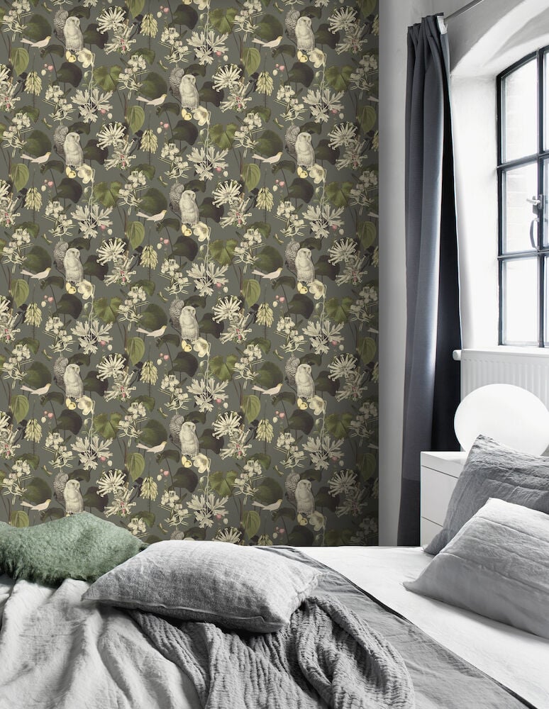 Vihreä satutapetti, jossa on eläimiä ja kasveja makuuhuoneessa.