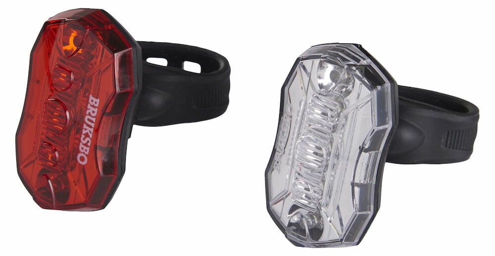 Röd och vit LED-cykellampa med svarta fästen.