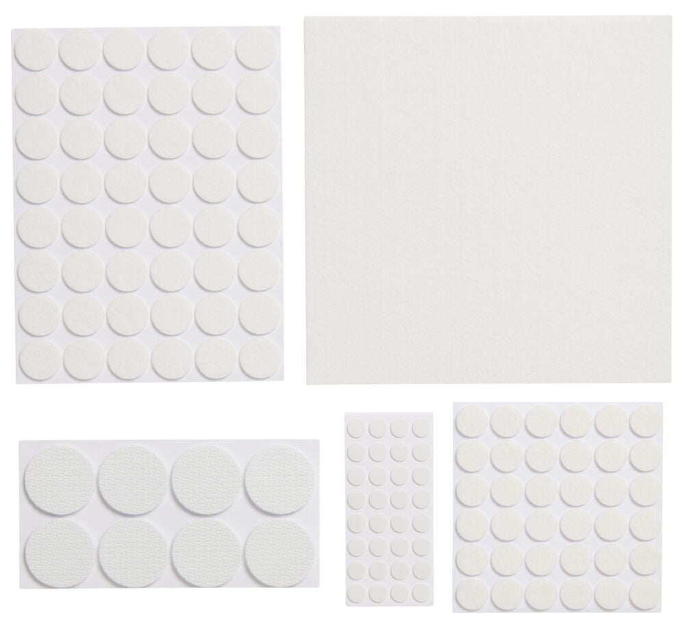 Vita självhäftande möbeltassar i olika storlekar.