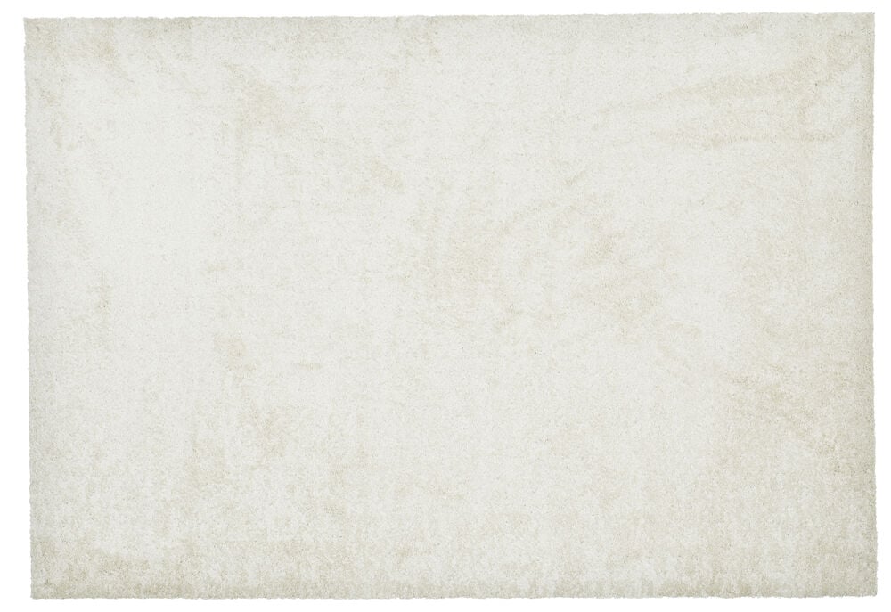 Suorakulmainen matto vaaleassa luonnonvärissä, jossa on lyhyt nukka.