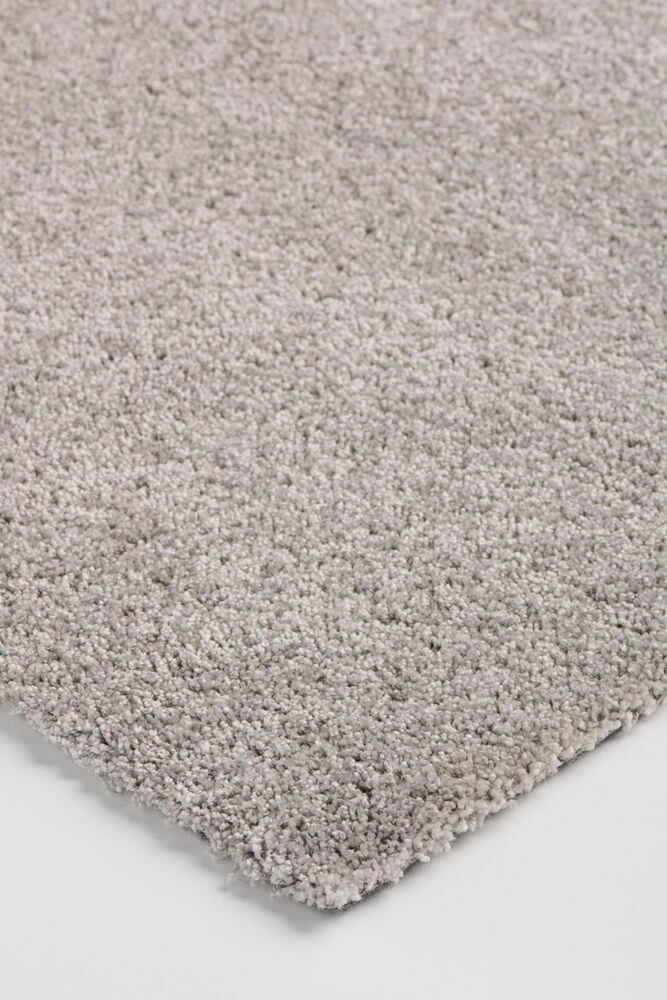 Harmaa Polypropeeni Matto Lizette 200x290 cm pörröisellä tekstuurella, kuvattuna viistosti lähikuvana.