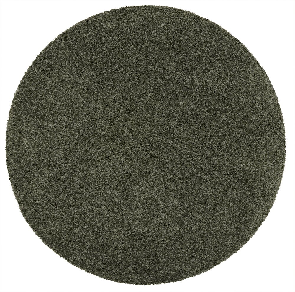 Pyöreä vihreä lyhytnukkainen matto kiiltävällä pinnalla.