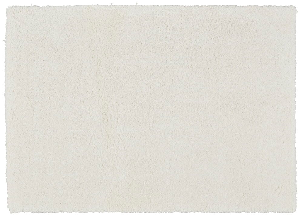 Valkoinen suorakulmainen ryijymatto, jossa on pehmeä ja paksu nukka.