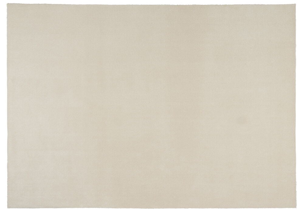 Suorakulmainen kermanvärinen matto, jossa sileä pinta.