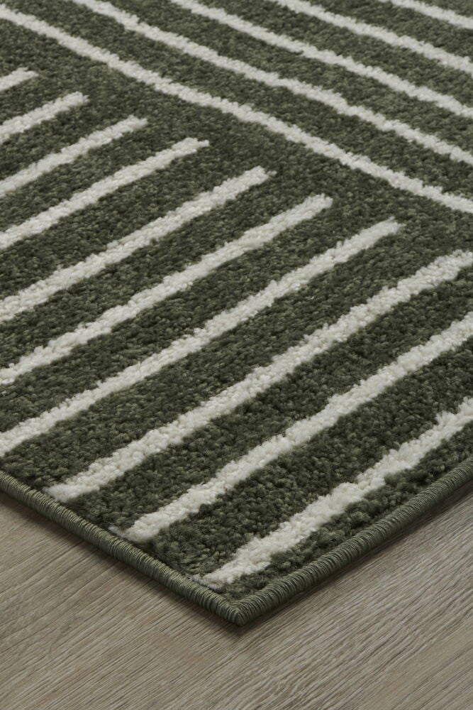 Grön matta med vitt grafiskt mönster.