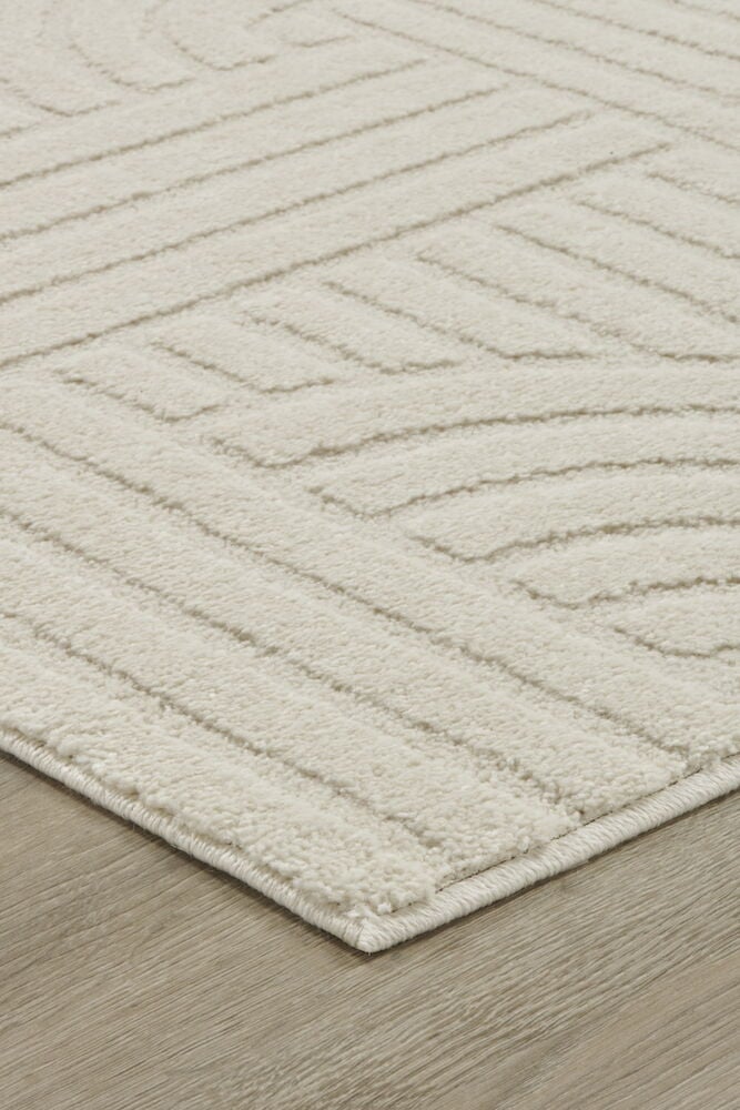 Ljus cremefärgad matta med grafiskt mönster.