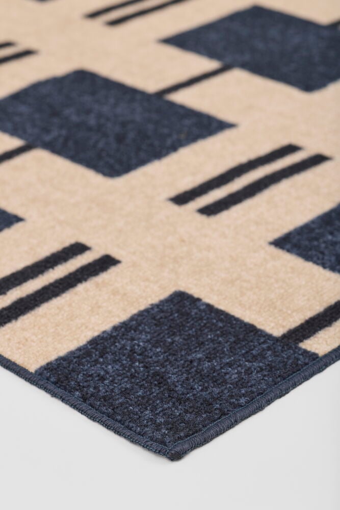 Blått Polyamid Teppe Ellinor med geometrisk blått og beige mønster.