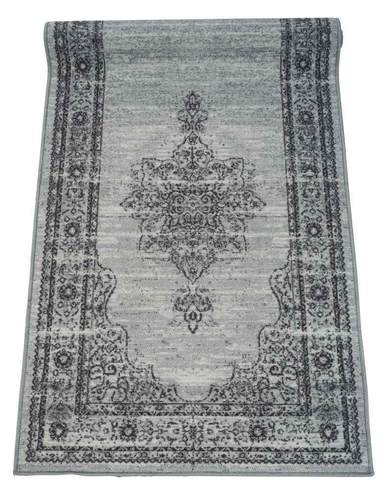 Harmaa käytävämatto, jossa kuvio ja kehys.