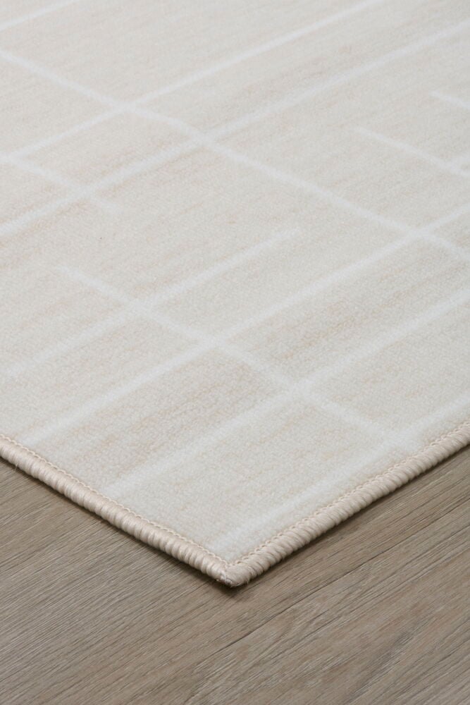 Vaaleanbeige käytävämatto, jossa on graafinen kuvio lattiassa.