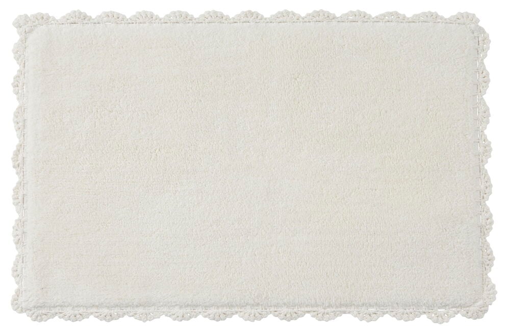 Rektangulär vit bomullsmatta med dekorativa kanter.