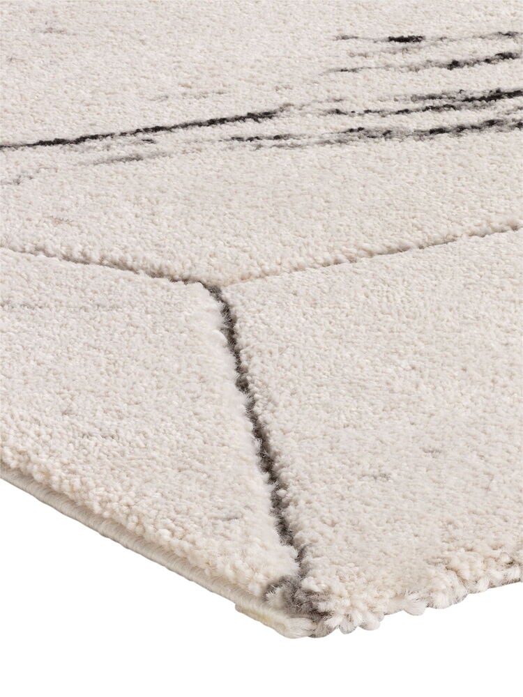 Valkoinen matto, jossa harmaa marmorointi ja reunayksityiskohta.