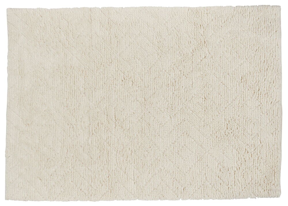 Rektangulär handvävd ullmatta i naturvit färg.