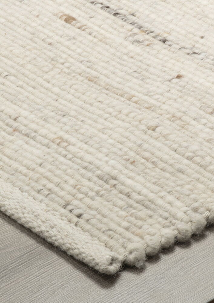 Handvävd mörkbeige ullmatta med melerat mönster.