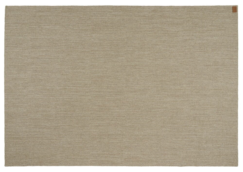 Käsinkudottu ruskea matto, punottu ilman nukkaa.