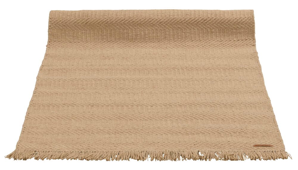 Beige Wollauflage mit Fransenkante.