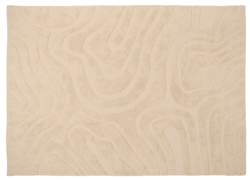 Luonnonvalkoinen puuvillamatto Dizzy, jossa kohokuvioitu aaltoileva abstrakti kuvio, ylhäältä nähtynä.