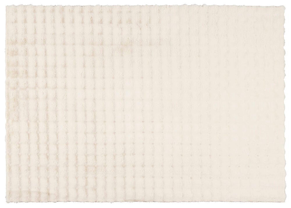 Ljusbeige fluffig matta med mjuk pälsliknande yta.
