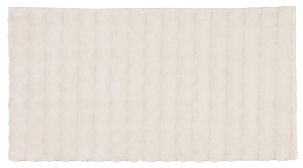 Ljusbeige tygstycke med vågig struktur.