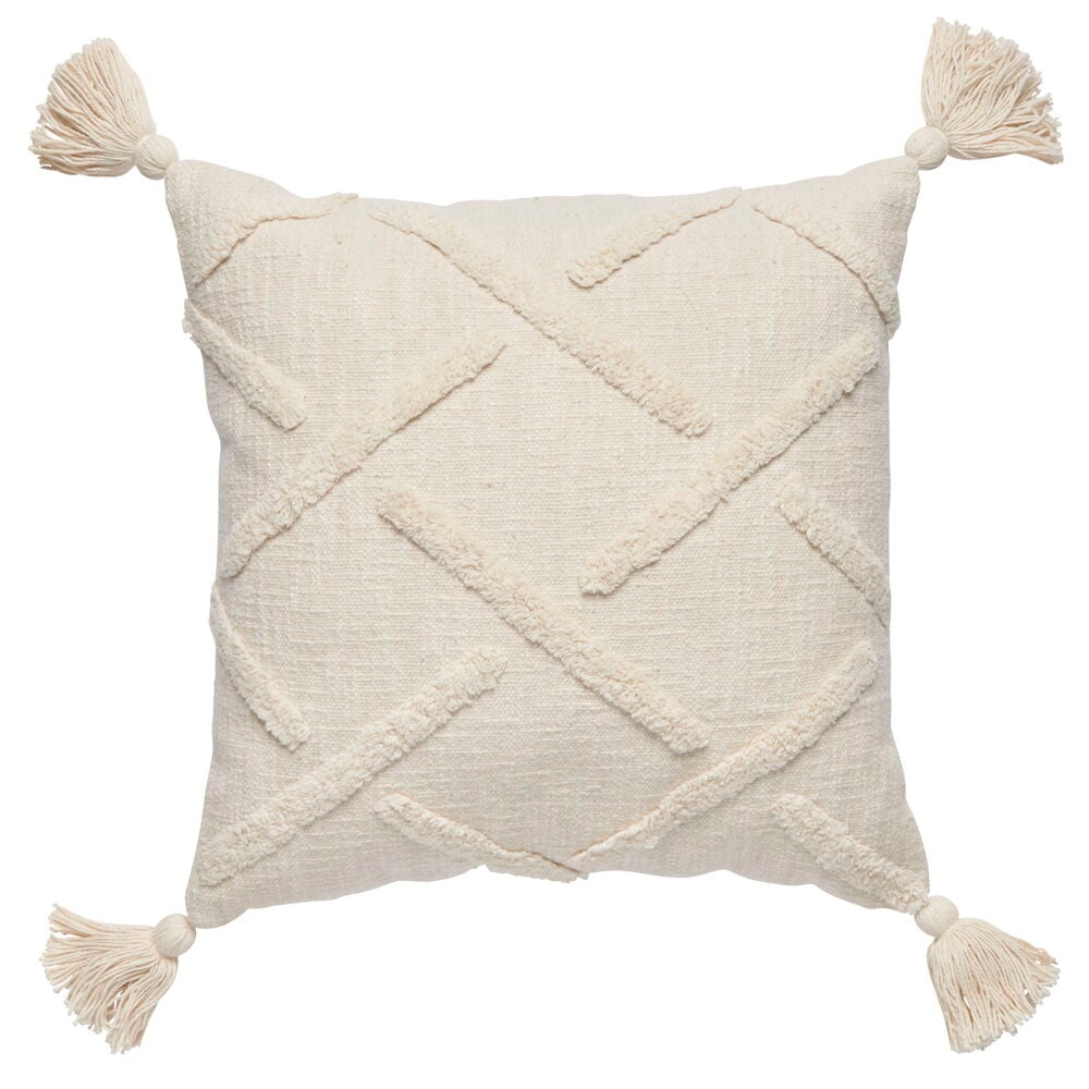 Offwhite kudde med tuftat mönster och hörntofsar.