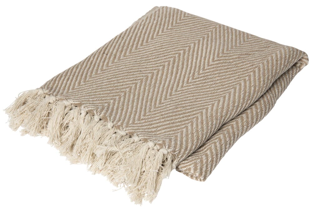 Beige Decke mit Fischgrätenmuster und Fransenrand.