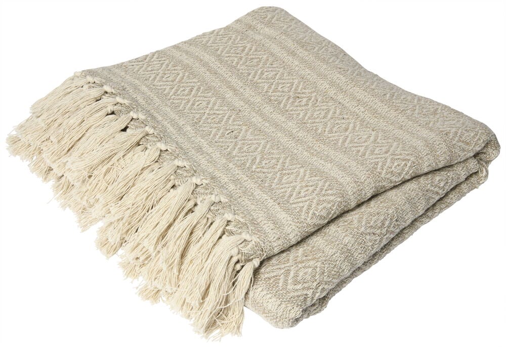 Beige Baumwolldecke mit Fransen hoch gestapelt.