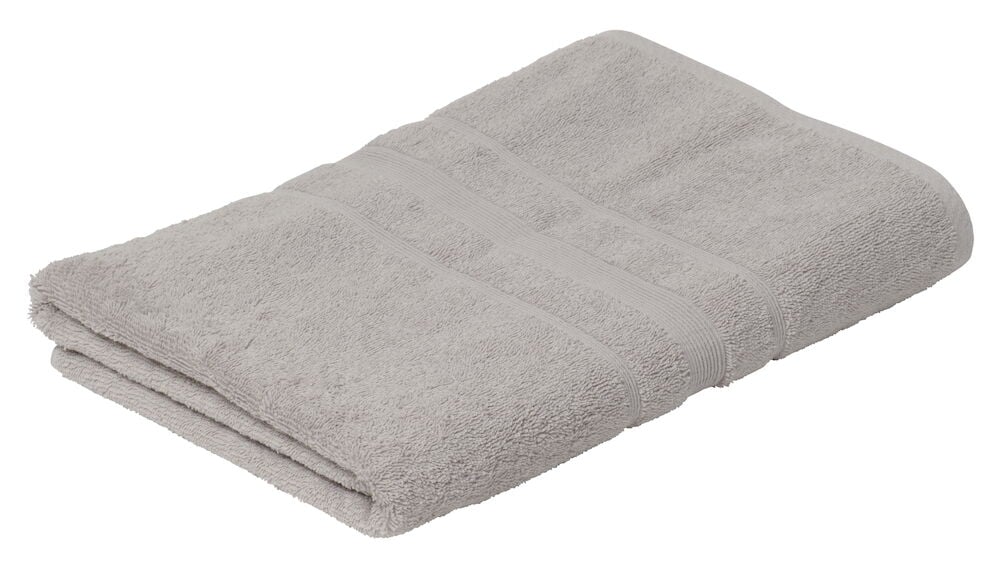 Taitettava hopeanvärinen puuvillainen kylpypyyhe.