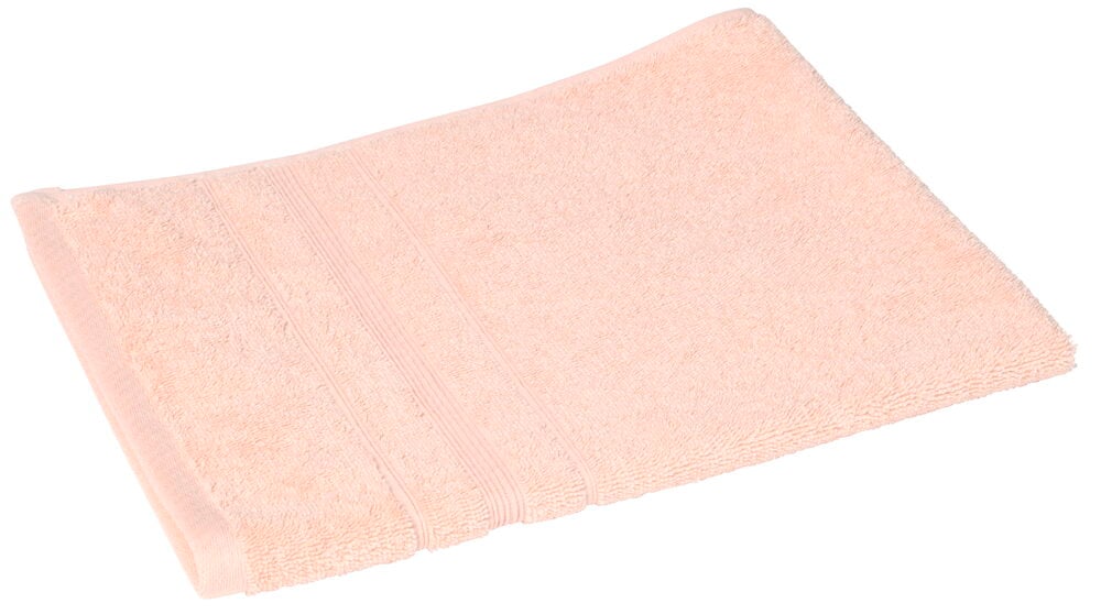 En vikt ljusrosa handduk av bomull.