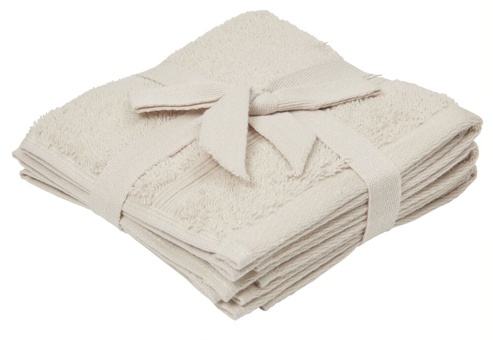 Drei gefaltete sandfarbene Waschlappen mit Bändern.