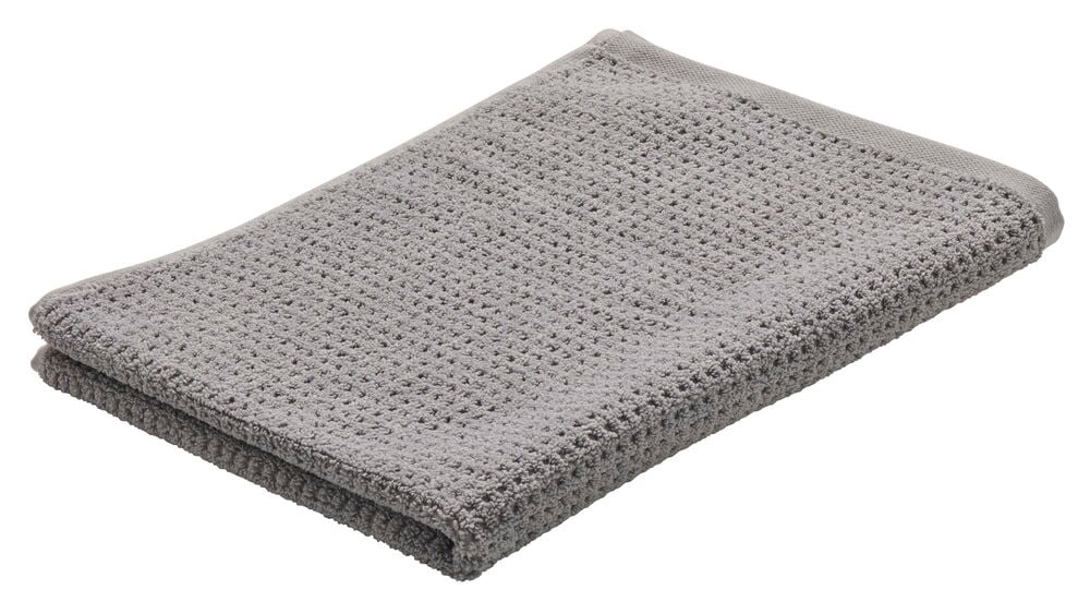 Yksi harmaa puuvillakangas pyyhe.