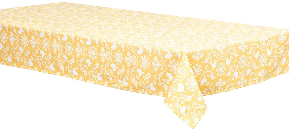Gul duk med dekorativt fågel- och bladmönster.