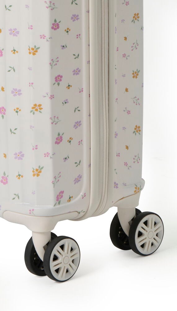 Kabinväska Regent Premium, vit med litet färgglatt blommönster, synlig dragkedja och hjul, närbild.