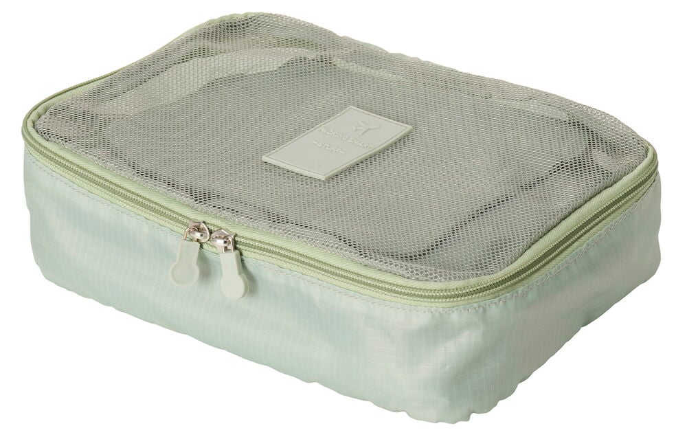 Grön packkub med nättopp och dragkedja.