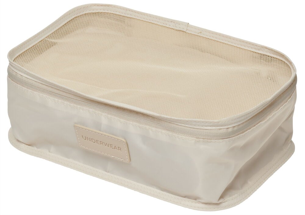 Beige packkub med genomskinligt meshlock.