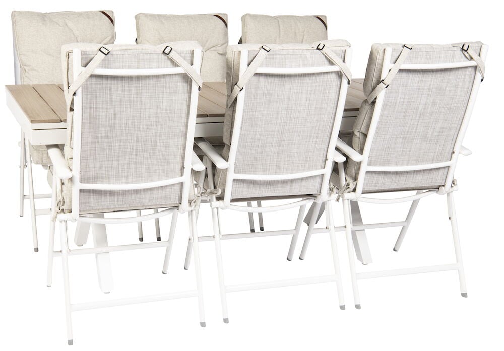 Valkoinen jatkettava pöytä, jossa on kuusi pehmustettua tuolia.